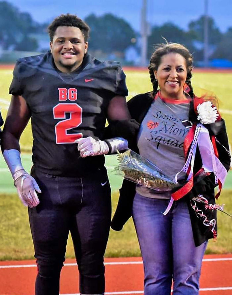 Kaleo Dade, left, stands with his mother, Tiffany Coleman-Dade, during Davis’ senior night recognition